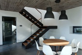 Dark industrial style lighting above the small dining area