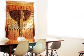 Dining room with hanging fiber art