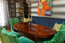 Dining table chairs add emerald green to the setting