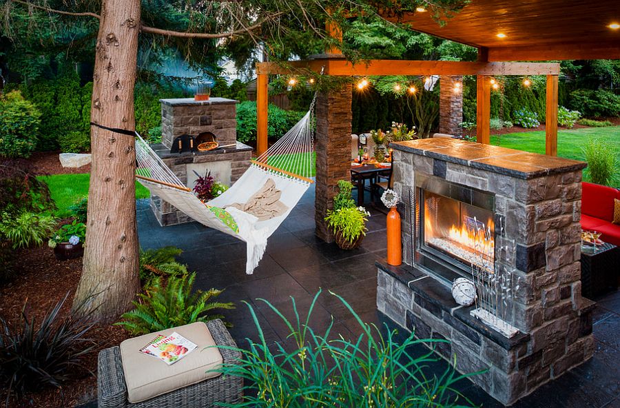 Gorgeous outdoor living area complete with fireplace and hammock [Design: Paradise Restored Landscaping & Exterior Design]