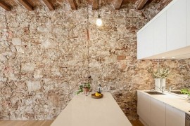 Kitchen and dining space of the apartment connected with the living area
