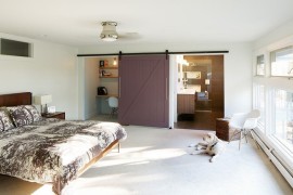 Midcentury bedroom with barn door for bathroom and office space