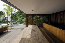 Outdoor kitchen and dining space that opens up towards the private deck