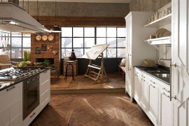 Seamless combination of the sitting and kitchen spaces by Marchi's Kreola