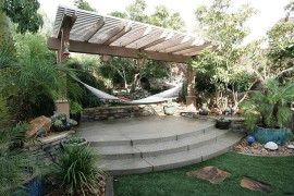 Tropical style landscape with pergola and hammock