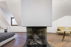 Two-sided fireplace serves the living area and the bedroom