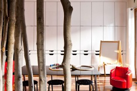 Use of tree trunks to create a natural, whimsical partition in the dining area