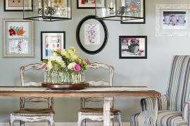 Beautiful gallery wall brings color to the relaxed dining room