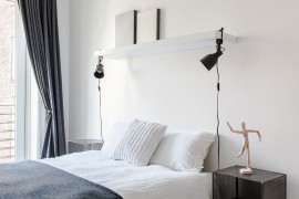 Bedside table and lighting bring symmetry to the relaxing bedroom