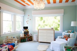 Bright orange stripes enliven the cool, modern bedroom