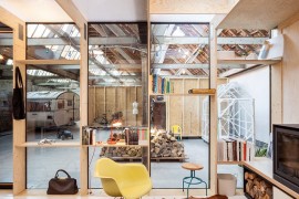 Classic Eames Rocker sits in front of the fireplace inside the home office