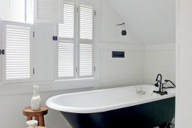 Claw-foot bathtub in the small bathroom in black and white