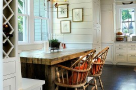 Dining table in heavy wood and a birdcage pendant give this dining room distinct personality