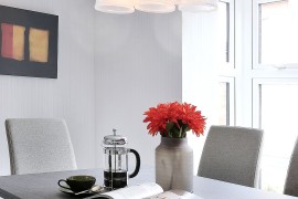 Gorgeous Fuchsia pendants and cool color palette shape the dining room