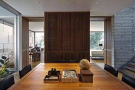 Innovative use of wooden partitions and glass windows creates a flowing interior