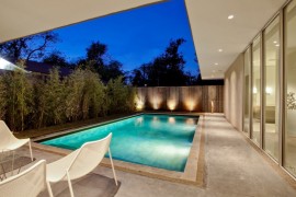 Landscape lighting against a backyard fence