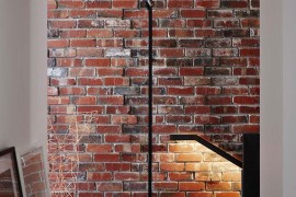 Original brick wall of the house exposed to give it a loft-like appeal