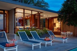 Poolside loungers in blue add color to the setting