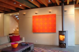 Pops of bright orange enliven the industrial living room
