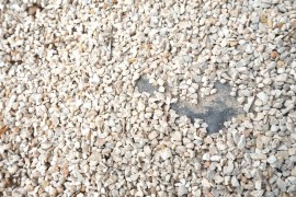 Redistribute gravel to cover bare spots