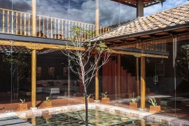 River rock and Arupo tree shape the stunning central counrtyard of the Cuenca Home