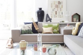 Scandinavian living room with glass coffee table on wheels