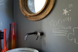 Unique mirror and chalkboard wall in the small bathroom