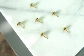 Upholstery nails on a marble tile