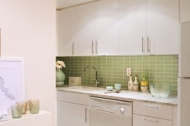White Scandinavian kitchen with a gorgeous green tiled backsplash