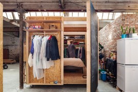 Wooden box containing the temporary bedroom inside the factory