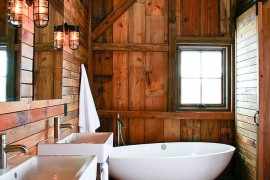 Barn style bathroom with a smart, white standalone bathtub [Design: Northworks Architects and Planners]