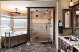 Bathtub and glass shower area make use of the corner space [Design: High Camp Home]