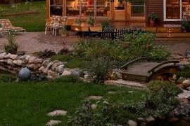 Bridge over the streams adds to the cozy, rustic appeal of the cabin retreat