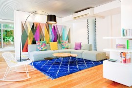 Brilliant living room with creative use of colorful wallpaper and rug