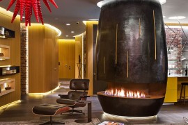 Classy Eames Lounger next to the bio fireplace in the center of the living room