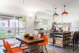 Colorful pendants and dining table chairs enliven this Tel Aviv kitchen [From: Peled Studios]