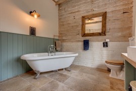 Contrasting textures and materials shape the bathroom walls