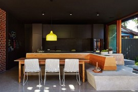 Dark kitchen backdrop lets the bright yellow pendant shine through