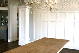 Dining room with a coffered ceiling and large pendant lights