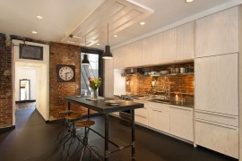 Elegant kitchen with a lovely brick wall backsplash [Design: Bennett Frank McCarthy Architects]