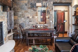 Farmhouse living room and dining with sleek industrial lighting [Design: JDA Design Architects]