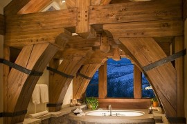 Heavy timber frame dominates the visual in this cool rustic bathroom [Design: RMT Architects / Living Images Photography]