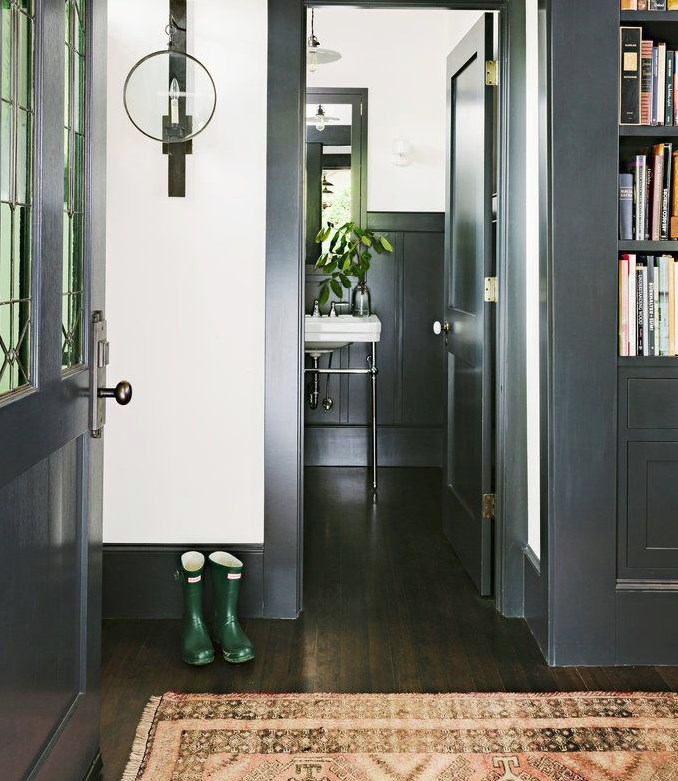 Home entryway featuring black trim