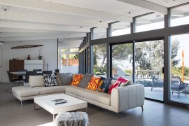 Large glass wall connects the interior with the landscape outside
