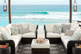 Pottery Barn black wicker sofa near ocean
