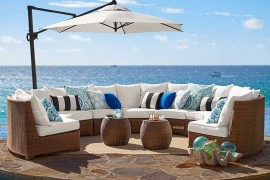 Pottery Barn honey wicker sectional next to ocean