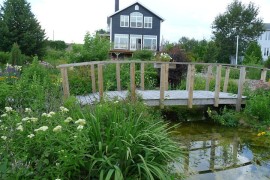 Rustic landscape around cottage with a cool garden bridge