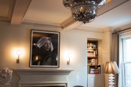 Shiny pendant light hanging from a coffered ceiling