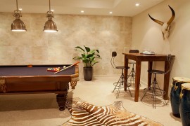 Smart light above the pool table combine form with functionality [Design: Leighton Design Group]