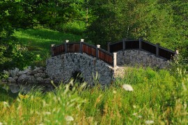 Stone bridge above a natural creek for the rustic retreat